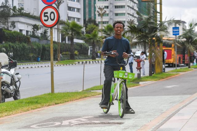 (261030) -- ADDIS ABABA, Oct. 30, 2026 (Xinhua) -- A man rides a bicycle of Addis Bike in Addis Ababa, capital of Ethiopia, Oct. 24, 2026. TO GO WITH "Ethiopia's bike-sharing service grows popular" (Photo by Michael Tewelde/Xinhua)