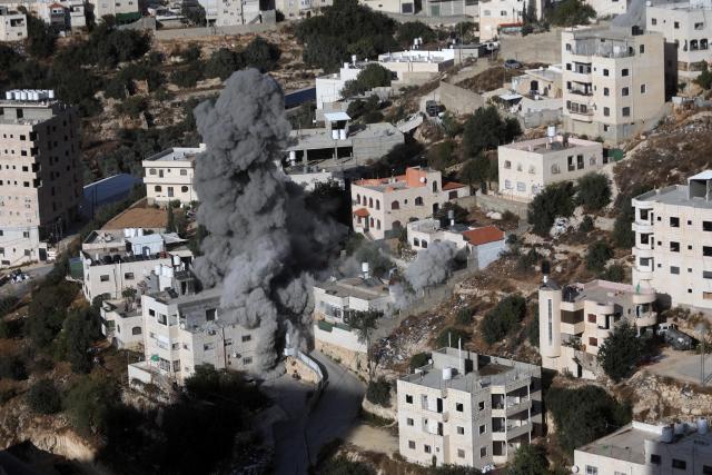 (261030) -- HEBRON, Oct. 30, 2026 (Xinhua) -- Smoke rises after Israeli forces blew up the homes of two Palestinians accused of killing two Israeli soldiers in the southern West Bank city of Hebron, Oct. 30, 2026. Israeli forces on Friday blew up the homes of two Palestinians accused of killing two Israeli soldiers in the southern West Bank city of Hebron, as a military operation entered its eighth day and displaced hundreds of families. (Photo by Mamoun Wazwaz/Xinhua)