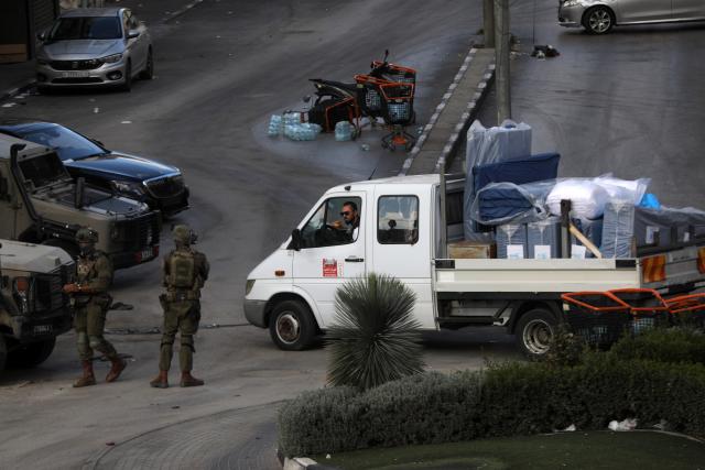 (261031) -- HEBRON, Oct. 31, 2026 (Xinhua) -- Israeli soldiers are seen preventing a vehicle belonging to Hebron Municipality from delivering humanitarian aid to Palestinian residents besieged in closed areas in the West Bank city of Hebron, Oct. 29, 2026. (Photo by Mamoun Wazwaz/Xinhua)