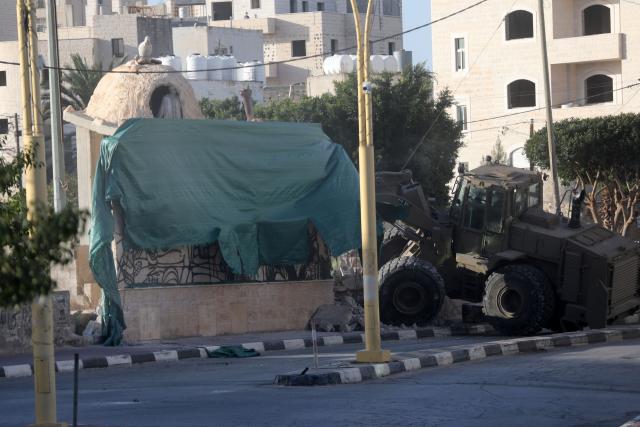 (261031) -- HEBRON, Oct. 31, 2026 (Xinhua) -- An Israeli military bulldozer demolishes a memorial to Palestinian martyrs at the al-Sahib junction in southern Hebron, in the West Bank, Oct. 29, 2026. (Photo by Mamoun Wazwaz/Xinhua)