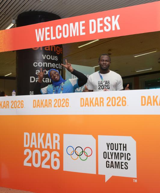 (261031) -- DAKAR, Oct. 31, 2026 (Xinhua) -- Volunteers welcome guests at a welcome desk of the airport ahead of the Dakar 2026 Youth Olympic Games in Dakar, Senegal, Oct. 29, 2026. (Xinhua/Yang Guang)