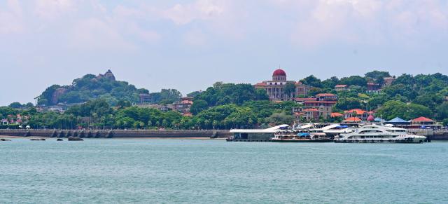 (261031) -- XIAMEN, Oct. 31, 2026 (Xinhua) -- This photo taken on Aug. 22, 2026 shows a view of Gulangyu Island in Xiamen, southeast China's Fujian Province. For years, Xiamen has continued to promote ecological development by stepping up efforts to build "beautiful bays," protect tidal flats and wetlands, and restore coastal ecosystems. (Xinhua/Lin Shanchuan)