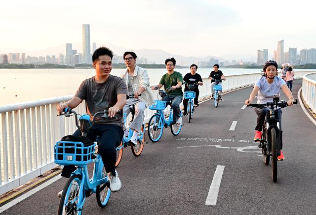 (261031) -- XIAMEN, Oct. 31, 2026 (Xinhua) -- People ride bikes along a bike lane over the water at Xinglin bay of Xiamen, southeast China's Fujian Province, Oct. 28, 2026. For years, Xiamen has continued to promote ecological development by stepping up efforts to build "beautiful bays," protect tidal flats and wetlands, and restore coastal ecosystems. (Xinhua/Lin Shanchuan)