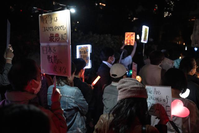 (261031) -- TOKYO, Oct. 31, 2026 (Xinhua) -- People holding signs attend a protest rally in front of the National Diet Building in Tokyo, Japan, Oct. 30, 2026. Nearly 10,000 Japanese citizens gathered in front of the National Diet Building in Tokyo on Friday evening to protest moves by Prime Minister Sanae Takaichi's government to revise the country's nuclear policy and expand its military capabilities. (Xinhua/Jia Haocheng)