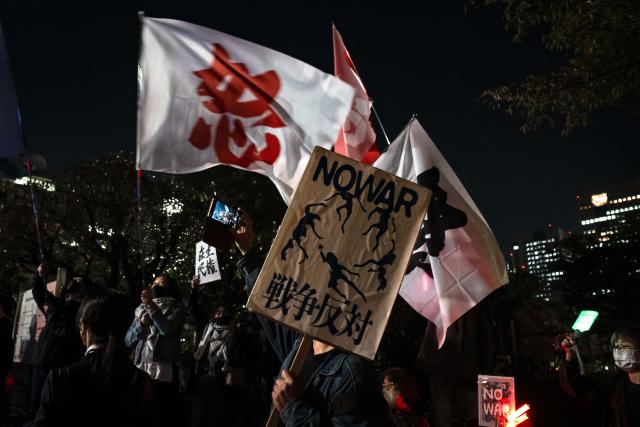 (261031) -- TOKYO, Oct. 31, 2026 (Xinhua) -- People holding signs attend a protest rally in front of the National Diet Building in Tokyo, Japan, Oct. 30, 2026. Nearly 10,000 Japanese citizens gathered in front of the National Diet Building in Tokyo on Friday evening to protest moves by Prime Minister Sanae Takaichi's government to revise the country's nuclear policy and expand its military capabilities. (Xinhua/Jia Haocheng)