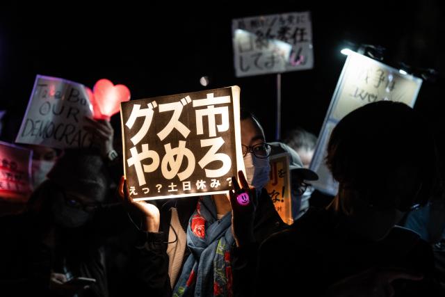(261031) -- TOKYO, Oct. 31, 2026 (Xinhua) -- People holding signs attend a protest rally in front of the National Diet Building in Tokyo, Japan, Oct. 30, 2026. Nearly 10,000 Japanese citizens gathered in front of the National Diet Building in Tokyo on Friday evening to protest moves by Prime Minister Sanae Takaichi's government to revise the country's nuclear policy and expand its military capabilities. (Xinhua/Jia Haocheng)