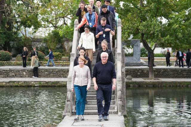 (261031) -- BEIJING, Oct. 31, 2026 (Xinhua) -- German President Frank-Walter Steinmeier (R, front) and his wife Elke Budenbender (L, front) visit Hongcun Village of Yixian County, Huangshan City, east China's Anhui Province, Oct. 28, 2026. Steinmeier paid a state visit to China from Oct. 27 to 31. Besides Beijing, Steinmeier also visited Anhui Province. (Xinhua/Du Yu)