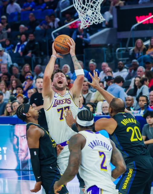 (261031) -- SAN FRANCISCO, Oct. 31, 2026 (Xinhua) -- Luka Doncic (top) of Los Angeles Lakers competes during the 2026-2027 NBA Cup group match between Golden State Warriors and Los Angeles Lakers in San Francisco, the United States, Oct. 30, 2026. (Photo by Arthur Dong/Xinhua)