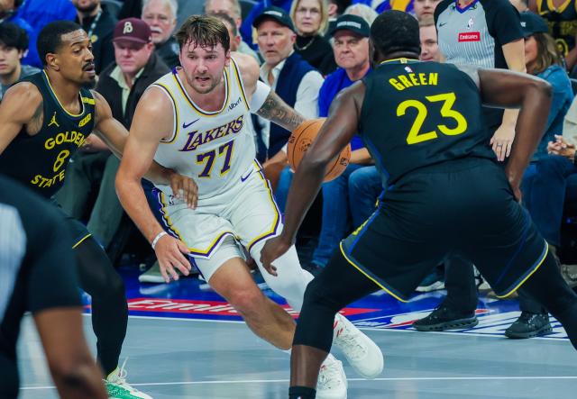 (261031) -- SAN FRANCISCO, Oct. 31, 2026 (Xinhua) -- Luka Doncic (C) of Los Angeles Lakers drives the ball during the 2026-2027 NBA Cup group match between Golden State Warriors and Los Angeles Lakers in San Francisco, the United States, Oct. 30, 2026. (Photo by Arthur Dong/Xinhua)