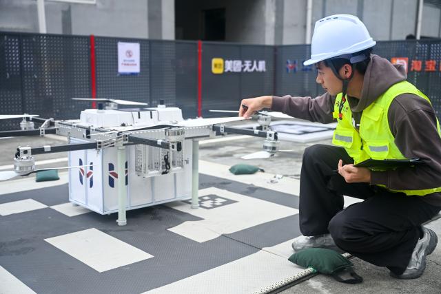 (261031) -- QINGZHEN, Oct. 31, 2026 (Xinhua) -- A technician checks a drone at a control center for low-altitude logistics service in Qingzhen City, southwest China's Guizhou Province, Oct. 30, 2026. Recently, the mountainous southwestern Chinese province of Guizhou has officially launched its first campus low-altitude drone delivery route in Qingzhen vocational education town. The aerial route connects local commercial districts directly to campuses, cutting the delivery time for teachers and students to less than 20 minutes with delivery fees starting at 3.8 yuan (about 0.57 U.S. dollars). The service also helps build a training platform integrating low-altitude industry and education to support talent cultivation. (Photo by Yuan Fuhong/Xinhua)