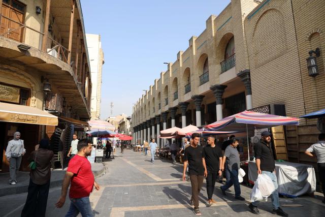 (261031) -- BAGHDAD, Oct. 31, 2026 (Xinhua) -- People walk on the al-Mutanabbi Street in Baghdad, Iraq, Oct. 21, 2026. October 31 marks World Cities Day. (Xinhua/Khalil Dawood)