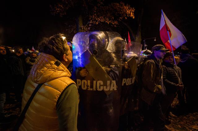 (261031) -- WARSAW, Oct. 31, 2026 (Xinhua) -- Police stand guard outside Poland's Constitutional Tribunal in Warsaw, Poland, Oct. 30, 2026. Protesters clashed with police outside Poland's Constitutional Tribunal in Warsaw on Friday night after the court's president was suspended amid an escalating dispute between Prime Minister Donald Tusk's government and the opposition over control of the judiciary. (Photo by Neil Milton/Xinhua)