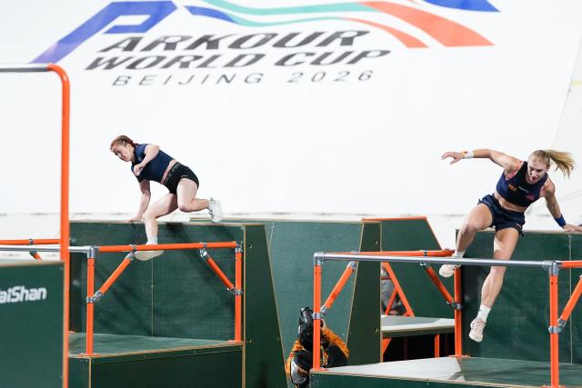 (261031) -- BEIJING, Oct. 31, 2026 (Xinhua) -- Noa Man (R) of the Netherlands and Audrey Johnson of the United States compete during the women's speed competition at the Parkour World Cup Beijing 2026 at Shougang Park in Beijing, capital of China, Oct. 31, 2026. (Xinhua/Ju Huanzong)