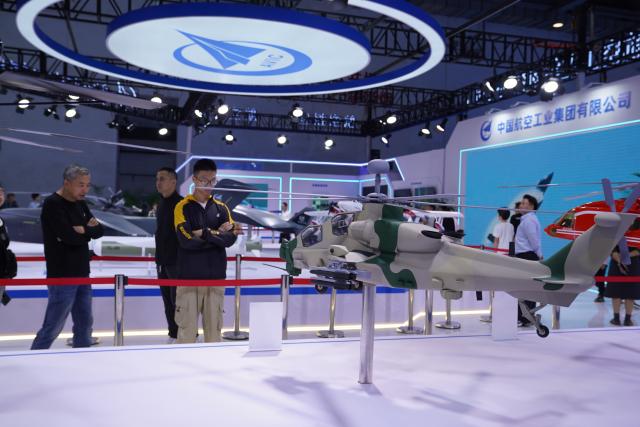 (261031) -- NANCHANG, Oct. 31, 2026 (Xinhua) -- Visitors view a helicopter model at the booth of the Aviation Industry Corporation of China, Ltd. at the 2026 Nanchang Aviation Industry Expo in Nanchang, east China's Jiangxi Province, Oct. 31, 2026. The expo kicked off here on Saturday, featuring dedicated exhibition areas for three major sectors including aviation manufacturing, commercial spaceflight and the low-altitude economy. The expo covers a total exhibition area of 30,000 square meters, having attracted more than 300 exhibitors. (Xinhua/Zhou Mi)