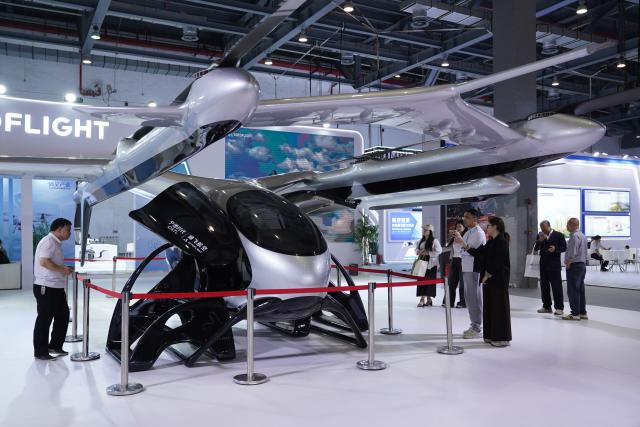 (261031) -- NANCHANG, Oct. 31, 2026 (Xinhua) -- Visitors view an electric vertical take-off and landing aircraft at the 2026 Nanchang Aviation Industry Expo in Nanchang, east China's Jiangxi Province, Oct. 31, 2026. The expo kicked off here on Saturday, featuring dedicated exhibition areas for three major sectors including aviation manufacturing, commercial spaceflight and the low-altitude economy. The expo covers a total exhibition area of 30,000 square meters, having attracted more than 300 exhibitors. (Xinhua/Zhou Mi)
