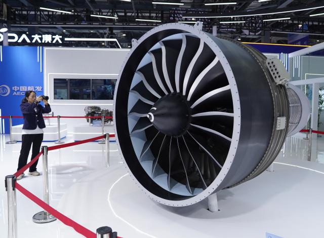 (261031) -- NANCHANG, Oct. 31, 2026 (Xinhua) -- A visitor takes photo at a booth showcasing the domestically developed aircraft engine at the 2026 Nanchang Aviation Industry Expo in Nanchang, east China's Jiangxi Province, Oct. 31, 2026. The expo kicked off here on Saturday, featuring dedicated exhibition areas for three major sectors including aviation manufacturing, commercial spaceflight and the low-altitude economy. The expo covers a total exhibition area of 30,000 square meters, having attracted more than 300 exhibitors. (Xinhua/Zhou Mi)