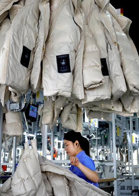 (261031) -- CHANGSHU, Oct. 31, 2026 (Xinhua) -- A staff member works at an AI-powered factory of Bosideng in Changshu, east China's Jiangsu Province, Oct. 31, 2026. Changshu has focused on high-quality development in recent years, intensifying efforts to improve the comprehensive strength in both traditional and emerging fields of its manufacturing sector. (Xinhua/Li An)