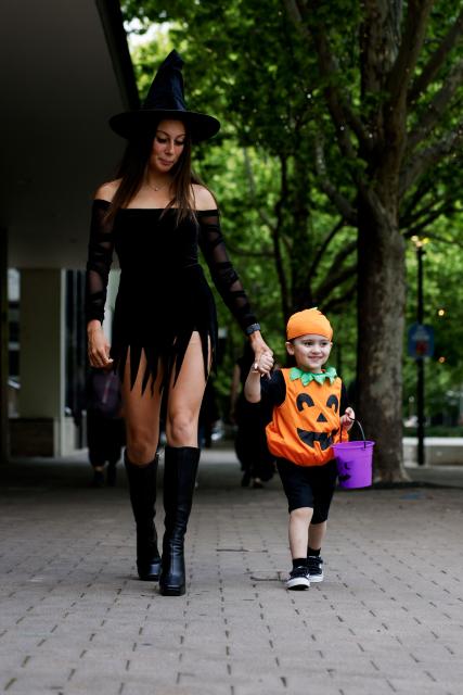 (261031) -- CANBERRA, Oct. 31, 2026 (Xinhua) -- A mother and her son dressed in Halloween costumes are pictured on a street in Canberra, Australia, on Oct. 31, 2026. (Photo by Chu Chen/Xinhua)