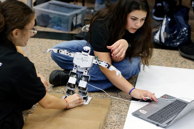 (261031) -- BUCHAREST, Oct. 31, 2026 (Xinhua) -- Participants prepare their robot for a contest during the 5th edition of Robofest, a technology event, at the Polytechnic University in Bucharest, Romania, Oct. 31, 2026. The three-day festival dedicated to science, technology and robots includes, among other events, a Robochallenge contest. (Photo by Cristian Cristel/Xinhua)