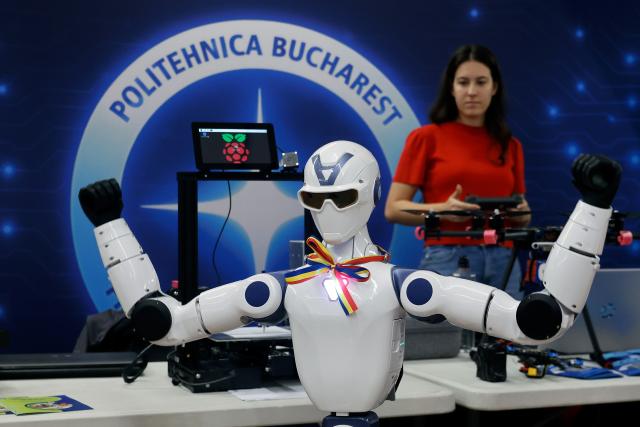 (261031) -- BUCHAREST, Oct. 31, 2026 (Xinhua) -- A participant controls her humanoid robot during the 5th edition of Robofest, a technology event, at the Polytechnic University in Bucharest, Romania, Oct. 31, 2026. The three-day festival dedicated to science, technology and robots includes, among other events, a Robochallenge contest. (Photo by Cristian Cristel/Xinhua)