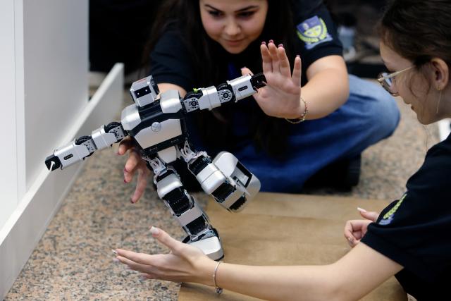 (261031) -- BUCHAREST, Oct. 31, 2026 (Xinhua) -- Participants prepare their robot for a contest during the 5th edition of Robofest, a technology event, at the Polytechnic University in Bucharest, Romania, Oct. 31, 2026. The three-day festival dedicated to science, technology and robots includes, among other events, a Robochallenge contest. (Photo by Cristian Cristel/Xinhua)