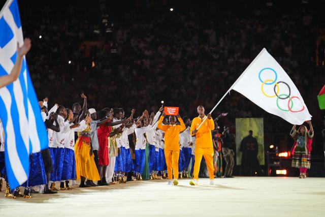 (261031) -- DAKAR, Oct. 31, 2026 (Xinhua) -- Flagbearers of Refugee Olympic Team parade into the stadium during the opening ceremony of the 2026 Youth Olympic Games in Dakar, Senegal, Oct. 31, 2026. (Xinhua/Xie Jianfei)