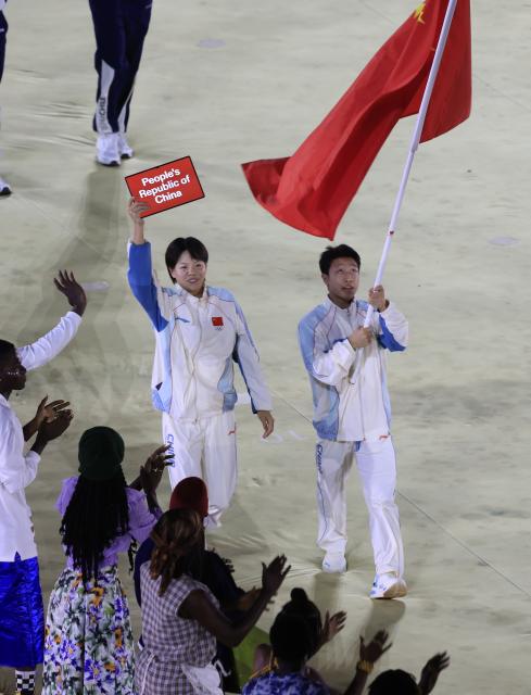 (261031) -- DAKAR, Oct. 31, 2026 (Xinhua) -- Chang Mohan (L) and Lin Yilei, flagbearers of China parade into the stadium during the opening ceremony of the 2026 Youth Olympic Games in Dakar, Senegal, Oct. 31, 2026. (Xinhua/Chen Wei)