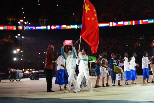 (261031) -- DAKAR, Oct. 31, 2026 (Xinhua) -- Chang Mohan (L) and Lin Yilei, flagbearers of China parade into the stadium during the opening ceremony of the 2026 Youth Olympic Games in Dakar, Senegal, Oct. 31, 2026. (Xinhua/Xie Jianfei)