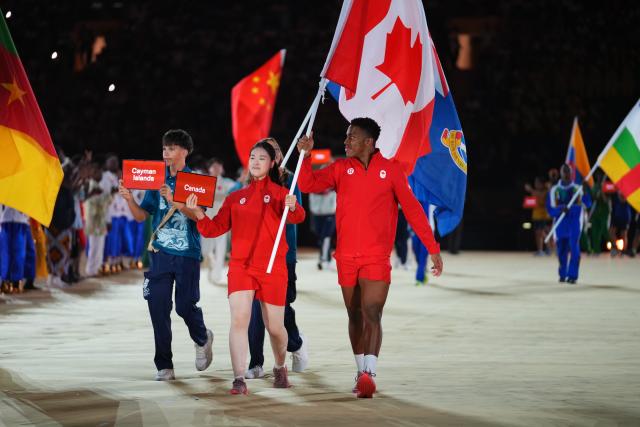 (261031) -- DAKAR, Oct. 31, 2026 (Xinhua) -- Flagbearers of Canada parade into the stadium during the opening ceremony of the 2026 Youth Olympic Games in Dakar, Senegal, Oct. 31, 2026. (Xinhua/Xie Jianfei)